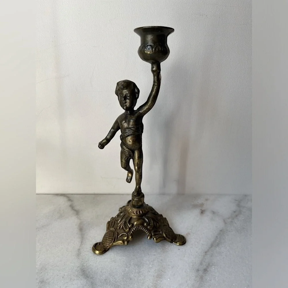 Antique cherub figurine candle holder